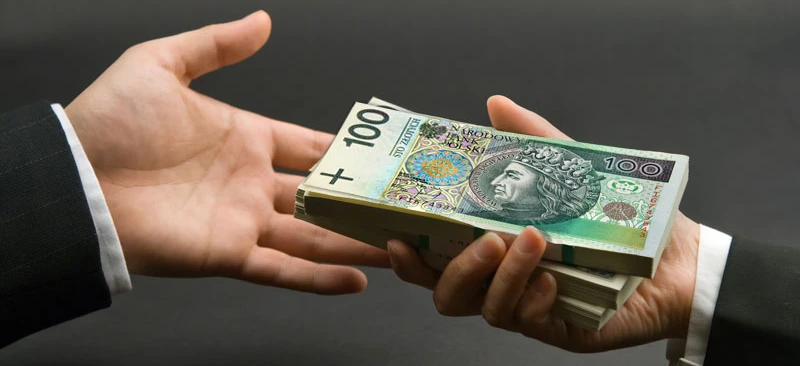 Polish banknote showing 100 złotych, with intricate design and text in Polish. Symbol of money handling and saving.